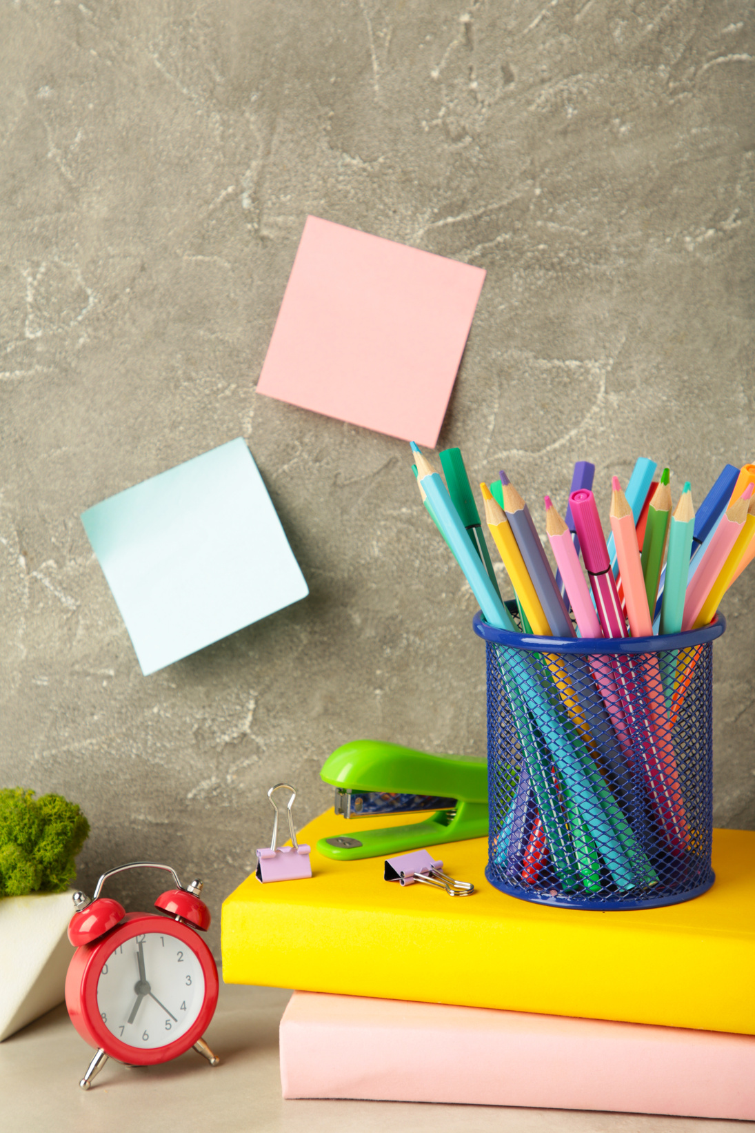 School Accessories Concept. Photo of Stationery on Grey Background. Vertical Photo
